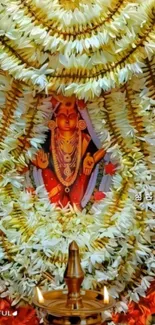 Floral adorned deity with vibrant garlands, perfect for a spiritual mobile wallpaper.