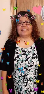 Smiling woman in a floral dress with decor.