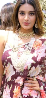 Woman in floral saree with intricate jewelry in portrait mode.