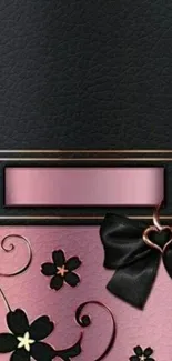 Elegant black and pink wallpaper with floral and bow design.