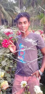 Person in a colorful flower garden with lush greenery.