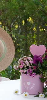 Serene garden wallpaper with flowers and straw hat on table.