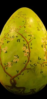 Green egg with floral design on black background.