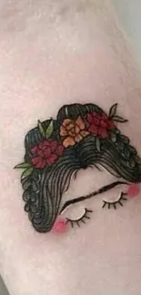 Delicate floral hair tattoo on arm showcasing minimalist design.