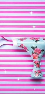 Floral patterned hairdryer on pink and blue striped wallpaper.