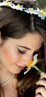 Woman with floral crown and flower in hand.