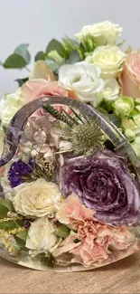 Heart-shaped resin piece with dried flowers in pastel hues.