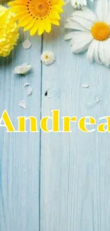 Mobile wallpaper with yellow daisies and name 'Andrea' on a blue wood background.