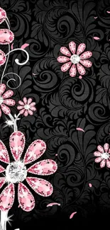 Mobile wallpaper with pink floral designs on a black background.