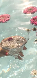 Pink daisies and floating flowers in a serene pool setting.