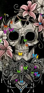 A detailed skull design with pink flowers set on a dark background.