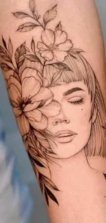 Elegant arm tattoo featuring floral art and a serene face in line drawing.