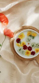 Delicate cup of flower tea on soft peach fabric.