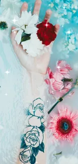 Tattooed hand in water with vibrant flowers and serene backdrop.