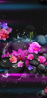 Black stones with pink flowers and water droplets.