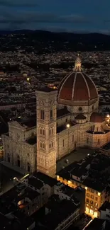 Florence Cathedral illuminated at night with city lights.