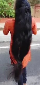 Woman with long black hair on street.