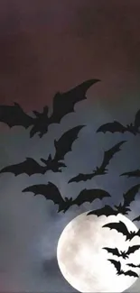 Bats silhouetted against a full moon night sky wallpaper.