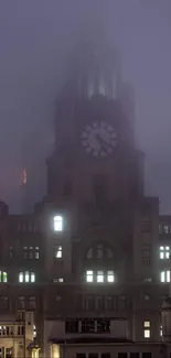 Foggy night view of a city with a clock tower.