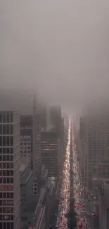 A foggy urban skyline with bright city lights at dusk.