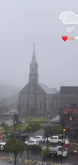 Gothic church surrounded by mist under a cloudy sky at 16°C.