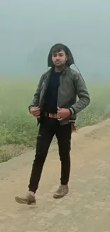 Man walking on foggy rural path in nature.