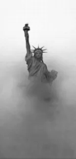 Black and white image of the Statue of Liberty in fog, creating an iconic scene.