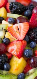 Colorful fruit salad with strawberries, kiwi, and grapes.