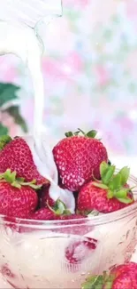 Fresh strawberries with milk pouring into glass bowl.