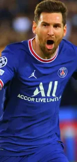 Footballer in blue jersey celebrating a goal in front of cheering crowd.