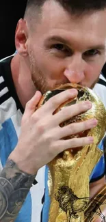 Football player kissing the trophy in pride.