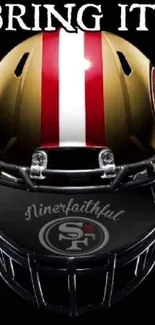 Football helmet with bold red and gold design on black background.