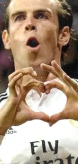 Football player making heart gesture in celebration.