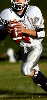 Football player in white uniform running on the field.