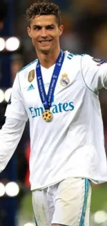 Soccer player celebrates victory with medal and thumbs up on the field.