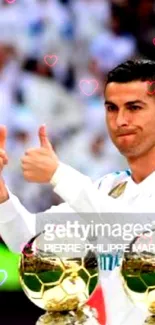 Football star giving thumbs up with trophies in front.