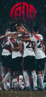 Soccer team huddle in rain, wearing white jerseys, showcases unity.