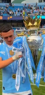 Player with Premier League trophy on field.