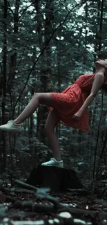 Woman in a red dress in serene forest setting.