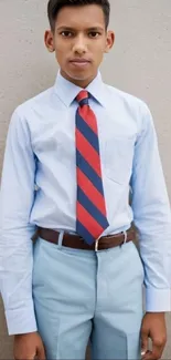 Youth in formal attire with a striped tie and light blue theme.