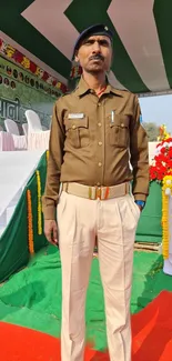 Uniformed man stands at a formal event in bright, outdoor setting with colorful decor.