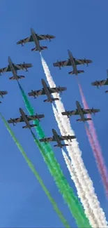 Jets in formation with colorful smoke against a blue sky.