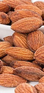 High-resolution mobile wallpaper of fresh almonds in a bowl.