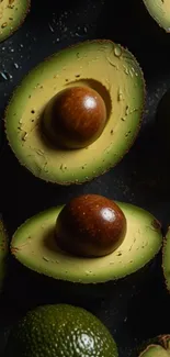 Close-up of sliced avocado halves with water droplets.
