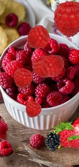 Fresh raspberries in a bowl surrounded by flowers.