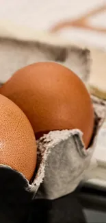 Wallpaper featuring fresh brown eggs in a rustic carton.