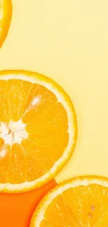 Vibrant orange citrus slices on a yellow background for phone wallpaper.