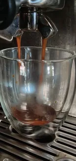 Espresso flowing into a glass mug from a coffee machine with rich brown hues.