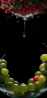 Juicy grapes and strawberries with water splash on black background.