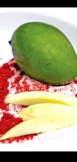 Green mango with red spices on white plate.